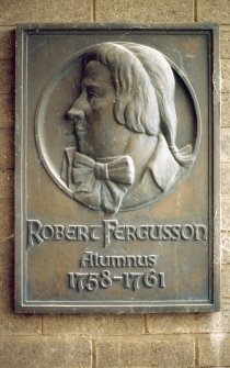 View of relief plaque portrait head of Robert Fergusson, on wall to left of side entrance to the Royal High School.