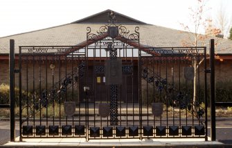 View of the Royal High School memorial playing fields gate, part of railings around playing fields opposite sports hall.