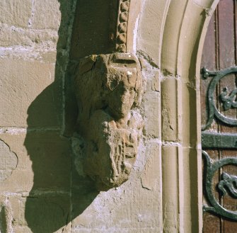Detail of corbel on hoodmould above main entrance.