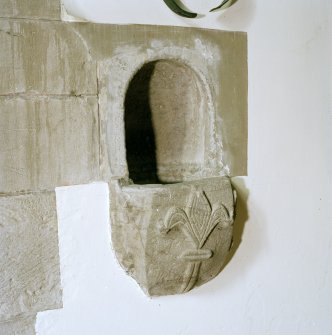 Interior.
View of stoup set into N wall.