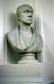 View of bust of an unknown man, in corner niche to left of door at end of box corridor.