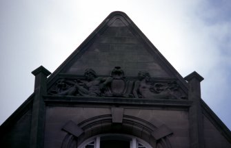 View of sculptures of a male and a female nude, above window of S gable on E side of building (North Bridge).