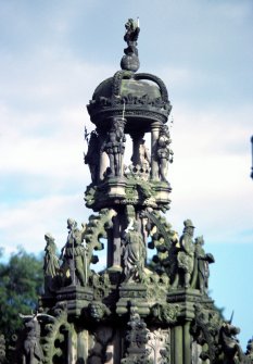 View of detail of top of Holyrood Fountain, showing the four halberdiers at the top, with (from left to right below) Queen Mary, the Earl of Stair, Lady Cranford (with hawk perched on her finger), John Cunningham (Town Drummer of Linlithgow), and Queen Margaret.