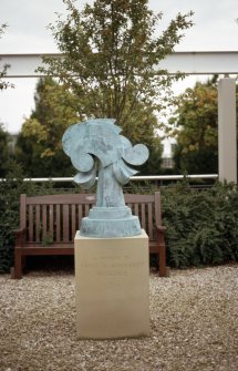 View of sculpture 'Fugues' (a tribute to David and Margaret Berridge), in paved area of small garden outside Equitable House, Lochside Crescent.