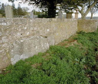 The large stone in the south wall of the churchyard from the west-south-west