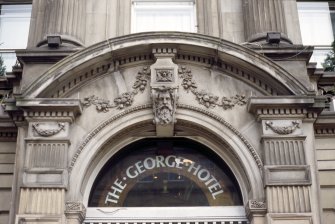 View of keystone head above entrance to The George Hotel.