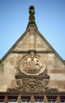 View of top of 70 Princes Street, showing Edinburgh coat of arms in roundel, and seated lion with shield on top of gable.