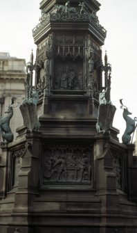 View of E side of pedestal of Monument to the Duke of Buccleuch, showing bronze panels. The upper panel shows the installation of the Duke as Chancellor of Glasgow University; the lower panel shows the attempted rescue of James V by Sir Walter Scott of Buccleuch and Branxholm in 1526.
