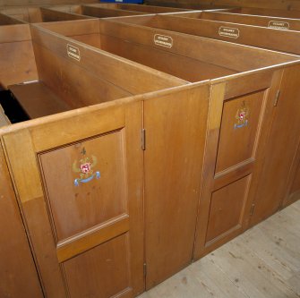 Interior: detail of St Martins Parish Church pews showing guild insignia