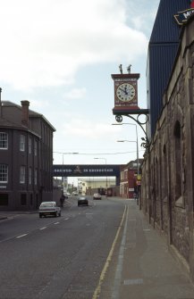 View of Fountain Brewery clock, attached to wall above war memorial.