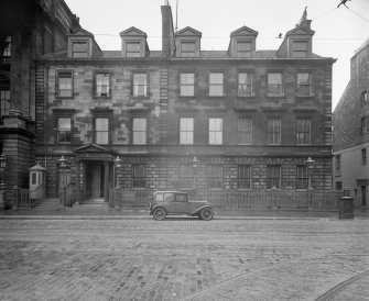 General view from West with car in front of the building