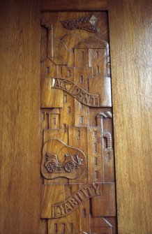 View of detail of carved wooden door, at corner entrance.