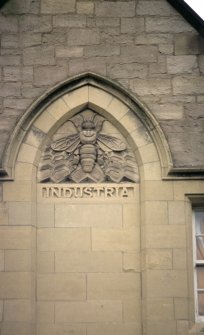 View of panel carved with a bee, on central gable of Kimmerghame House, Fettes College.