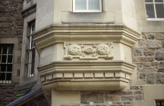 View of carved stone, below second floor window on S wall of Writers' Museum.