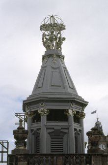 View of armillary sphere supported by children, on top of corner tower, 30 Princes Street.