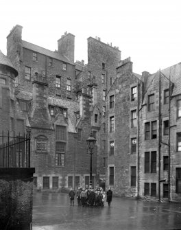 General view of Wardrop's Court, Edinburgh, centred on children gathered around a lamp post in the courtyard.
