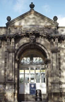 View of entrance arch, decorated with a female keystone head.