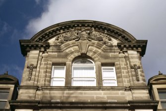 View of carved arms of the Merchant Company, in pediment above top floor windows.