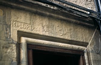 View of lintel carved with merchant's mark and inscription, above door on right, half-way down Boswell's Close.