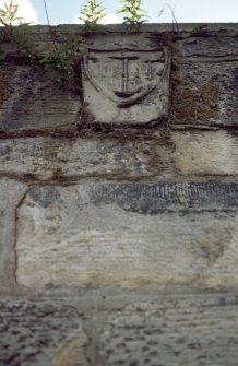 View of shield carved with three anchors, at top of wall.