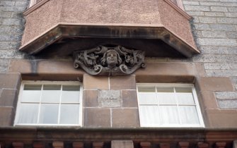 View of corbel head of a boy flanked by tools, beneath first floor oriel window of No.457 Lawnmarket.