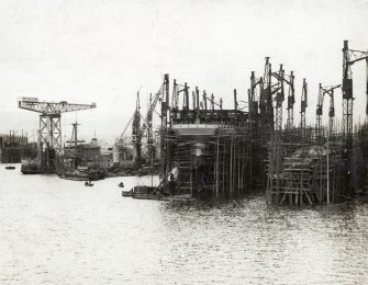 View of Aquitania under construction at John Brown's Shipyard, Clydebank. Cantilever crane to left (Arrol 150 ton, 1907)
Photographed by A Blackadder, W Nile St Glasgow
