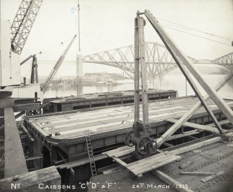 View of caissons, Rosyth dockyard with the Forth Bridge visible in the background.
Titled: 'No. Caissons C, D & F. 24 March 1913'.