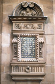 View of plaque commemorating the Lady Caroline Charteris Wing, on wall of W wing.