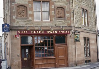 View of the Black Swan bar, showing panels carved with a swan (left) and the arms of Leith (right).