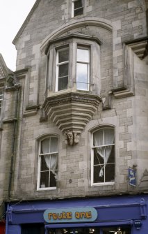 View of carved jester's head and arms, supporting oriel window of 29 Cockburn Street.