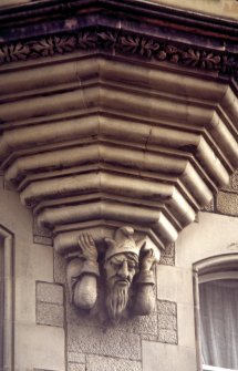 Detailed view of carved jester's head and arms, supporting oriel window of 29 Cockburn Street.
