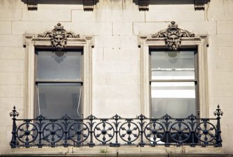 View of carved heads, above central second floor windows of 108-110 Princes Street.