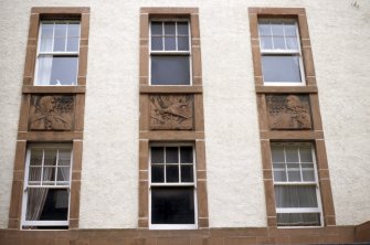 View of panels betwen windows, above entrance to 1940s extension to Leith Hospital Nursing Home (now flats).