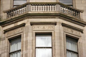 Detailed view of carving above bay window on second floor of 112 Princes Street.