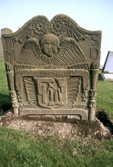 General view of gravestone of May Duff, 1762. Double rosette with double torches of Life and Death. Winged Soul over ribband insc: 'After Death Life. Hors Est Boni Viri Natalis'. Shield with the tools of a mason (setsquare, folding ruler, dividers chisel, hammer and mallet). Insc: 'D.M S.D'. 
