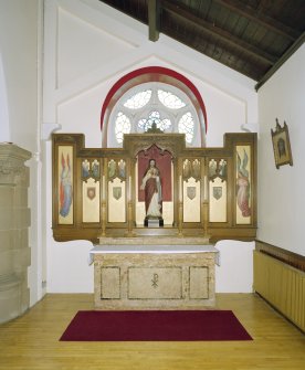 Interior. W side chapel, view of altar from N