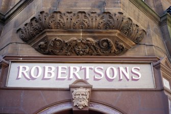 View of male keystone head and carved corbel, above entrance to Robertsons, 45 Rose Street.