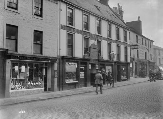 View of High Street, Dumfries, showing Dempsters and The hole I' the Wa Inn.
