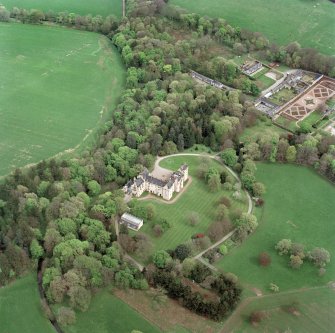 Oblique aerial view centred on Fyvie Castle with walled garden adjacent, taken from the WSW.