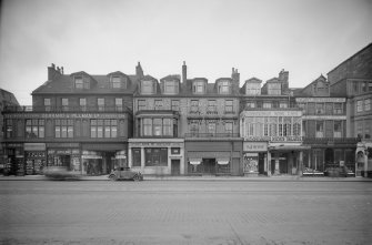 General view of Nos 130-134 Princes Street, Edinburgh, showing the premises John Sinclair Ltd, Hendersons, Scotch Wool & Hosiery Stores, Gerrard & Pillman Ltd manufacturing furriers, Union Bank of Scotland Limited, Russ & Winkler manufacturing furriers (no.134), R S McColl, Monsigneur News Theatre and Cafe, W Jamieson and Sons (no.130) and James Bacon & Sons Art Photography (no.130).
