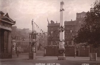 Historic photographic view of obelisk by the Royal Scottish Academy, showing the street decorated on the coronation day of Edward VII.