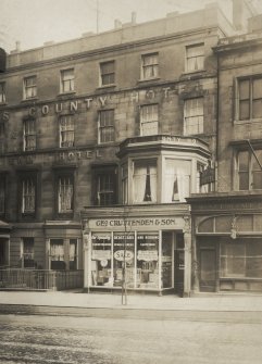 Historic photograph showing 21 Lothian Road, The County Hotel and Geo Cruttenden & Son shop.