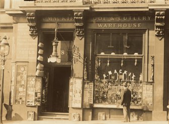 Historic photograph showing general view of shop front at No 8, A Mackie Cutler & Optician, Melbourne Place, Edinburgh. Since demolished.