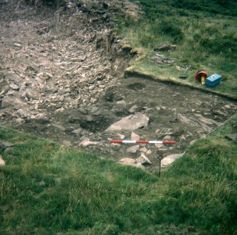 View from N of paving above pits during excavation; photographic scale in 200mm divisions