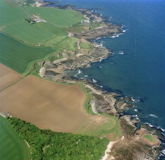 Oblique aerial view centred on the excavation of Auldhame chapel and cemetery and the remains of Tantallon Castle and dovecot with the scientific research establishment, farmsteading and remains of the laird¿s house adjacent, taken from the ESE.