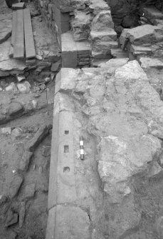 Jedburgh Abbey excavation archive
Frame 24: Area 2: Trench G: Sockets cut into chamfer of S face of Wall 385. From E.