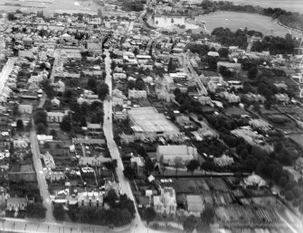 Elgin, general view, showing St Columba's Church of Scotland, Elgin Tennis Club and St Sylvester's Roman Catholic Church. Oblique aerial photograph taken facing north.