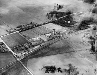 William Teacher and Sons Ltd. Ardmore Distillery, Kennethmont, Huntly.  Oblique aerial photograph taken facing south-west.  This image has been produced from a damaged negative.