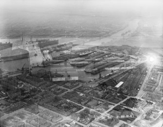 Glasgow, general view, showing Prince's Dock and River Clyde.  Oblique aerial photograph taken facing east.  The image is double exposed, also showing Cochran's Boiler Works, Newbie, Annan. 