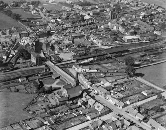 Lockerbie, general view, showing Lockerbie Station and St Cuthbert's Parish Church.  Oblique aerial photograph taken facing west.